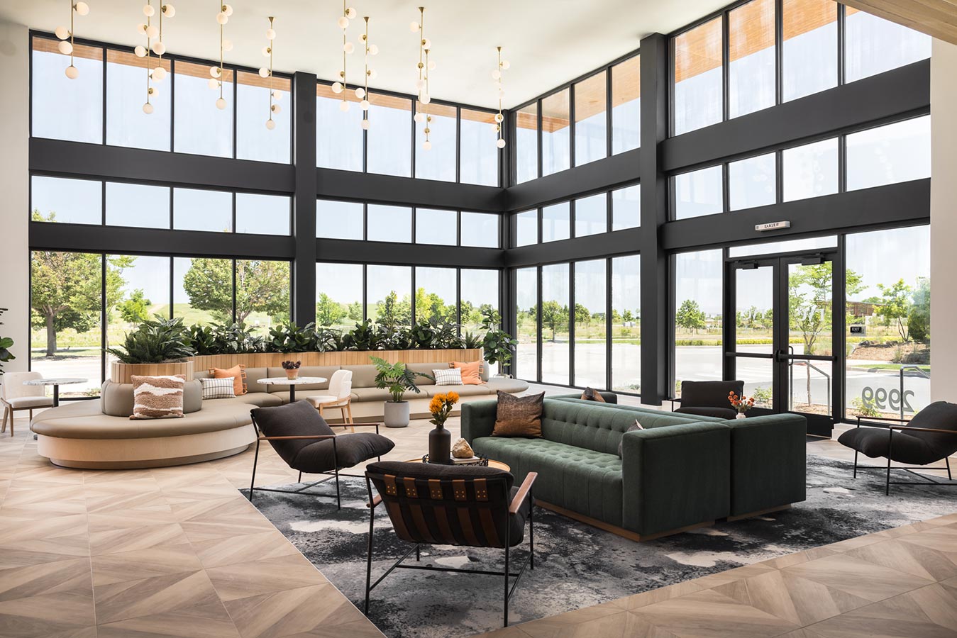 Sitting area in lobby with floor to ceiling windows for natural light