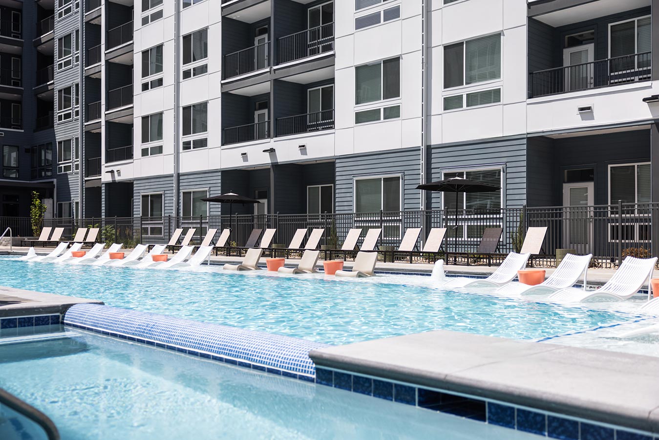Rye Central Park Pool area with lounge chairs in pool