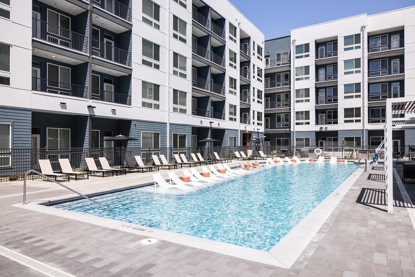 Rye Central Park Pool area with lounge chairs in pool