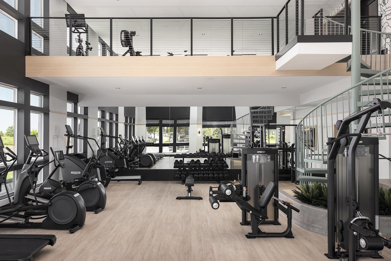 Two story gym with weights, machines, and treadmills