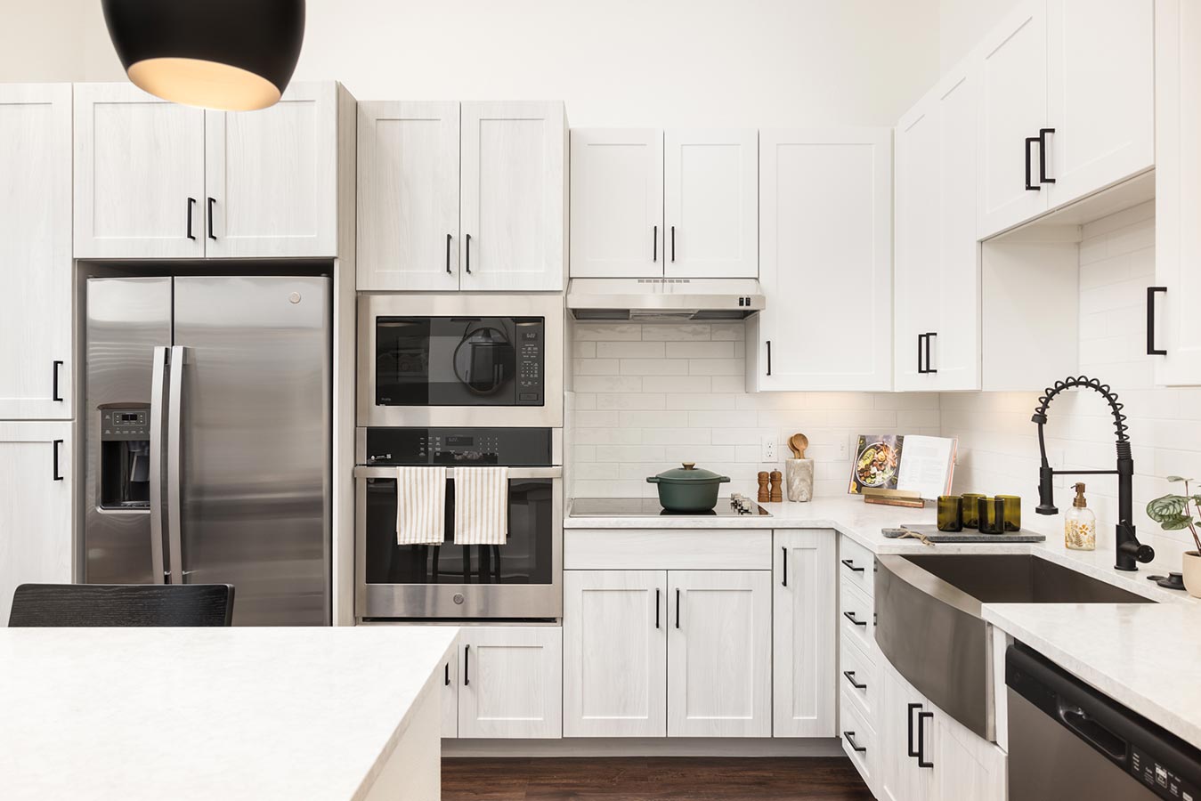 Kitchen with white wooden cabinets and stainless steel fridge