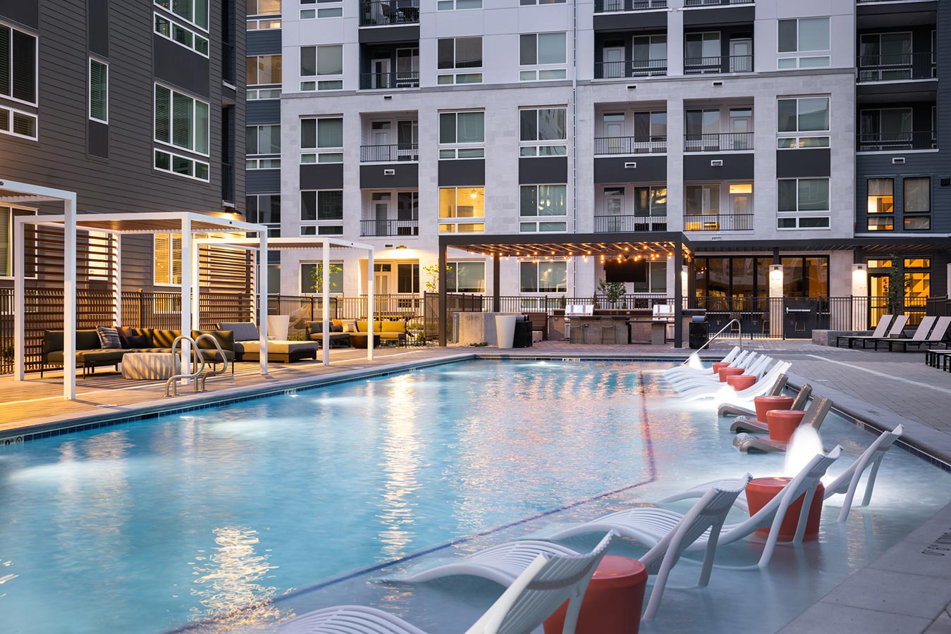 Rye Central Park Pool area with lounge chairs in pool and cabanas
